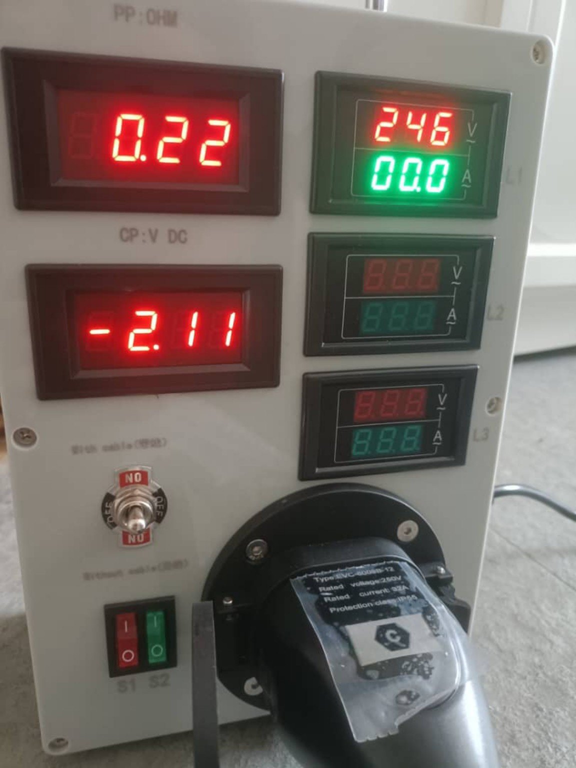 EV charger test equipment showing voltage and current readings